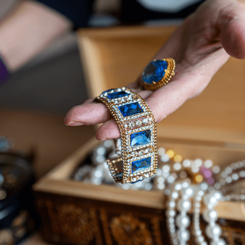 wooden-treasure-chest-with-valuables-female-holds-beads-necklaces-other-jewelry-her-hands (2) (1)